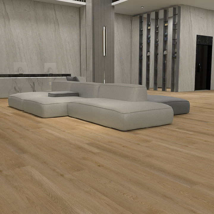 Modern gray sectional sofa in a room with wooden flooring and a neutral color palette.