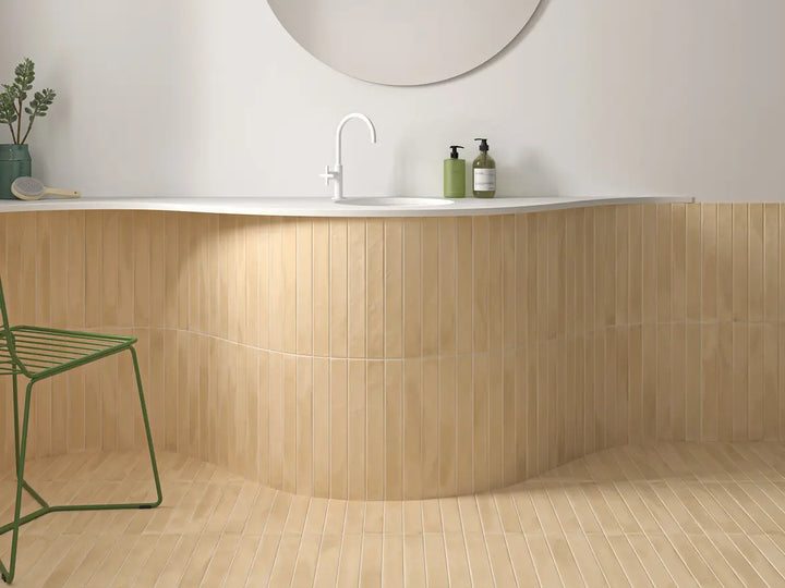 Bathroom with wooden wall panels, white countertop, and green stool.