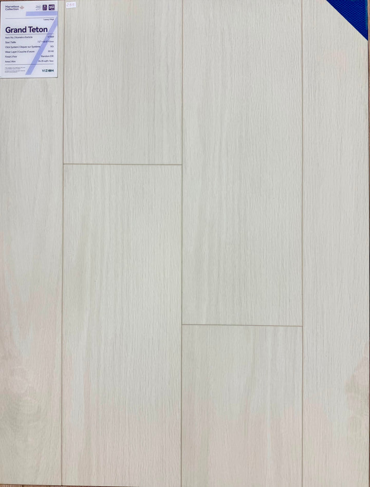 Light beige wood-look plank flooring with visible grain texture and a Grand Teton label in the upper left corner.