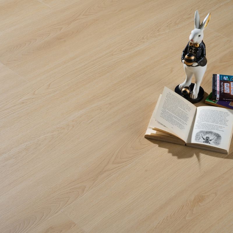 Close-up view of Grandeur Inov8 SPC vinyl flooring in Flowerpot Island shade, displaying realistic wood grain texture and subtle beige undertones.