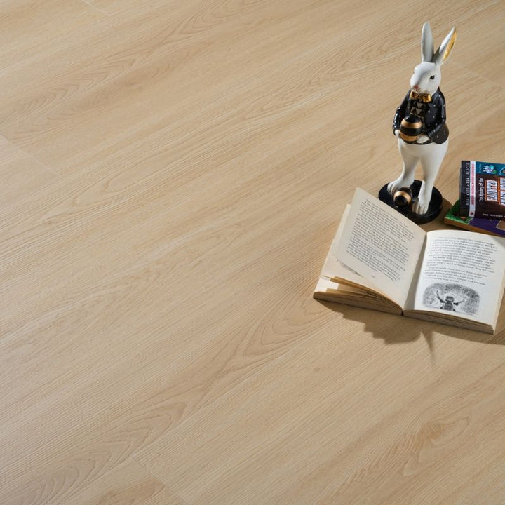 Close-up view of Grandeur Inov8 SPC vinyl flooring in Flowerpot Island shade, displaying realistic wood grain texture and subtle beige undertones.