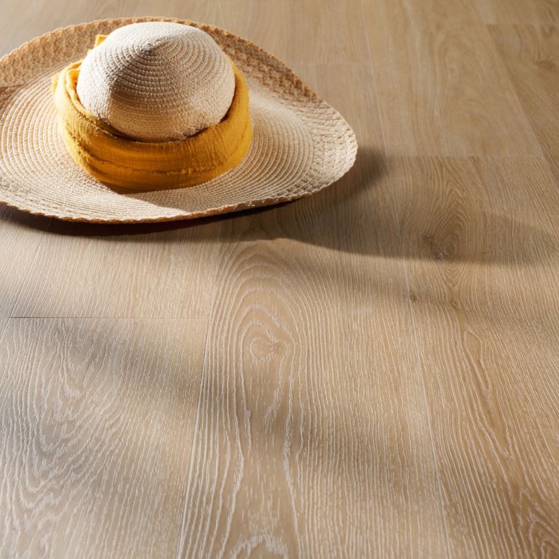 Close-up of Grandeur Inov8 SPC vinyl flooring in Tobermory shade, showing natural light wood grain texture and elegant matte surface.