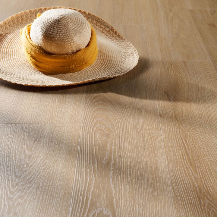 Close-up of Grandeur Inov8 SPC vinyl flooring in Tobermory shade, showing natural light wood grain texture and elegant matte surface.