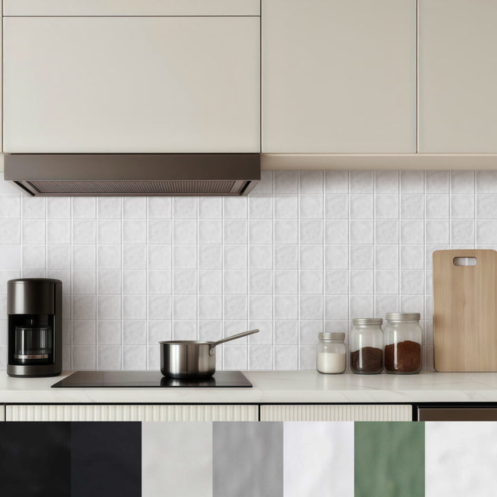 Modern kitchen with white tiled wall, countertop items, and neutral cabinets.
