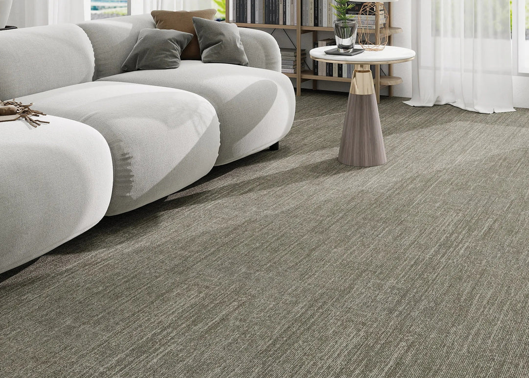 Modern living room with a gray sofa and patterned carpet