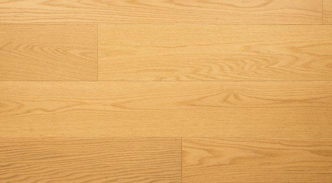 Close-up of a wooden floor with a warm brown color and visible grain pattern.