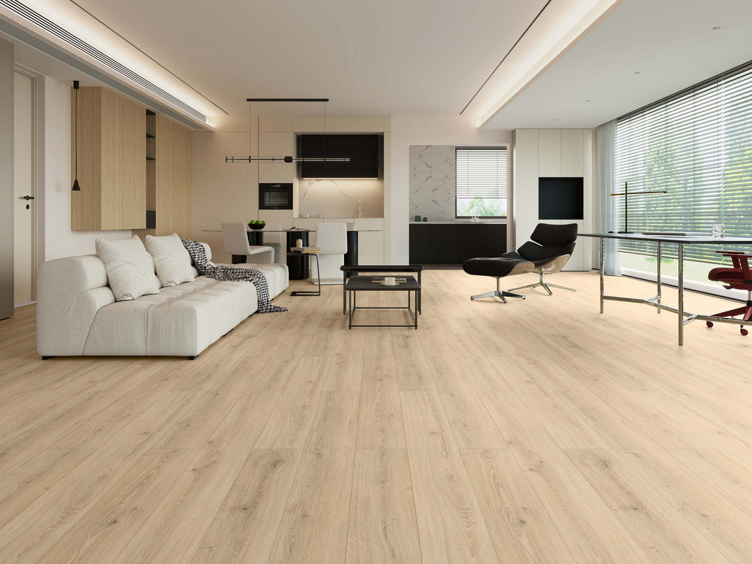 LV329 St.moritz, light rustic oak laminate flooring shown in a modern, bright open-plan living room with a white sectional sofa. Available at Advanced Flooring Waterloo. 