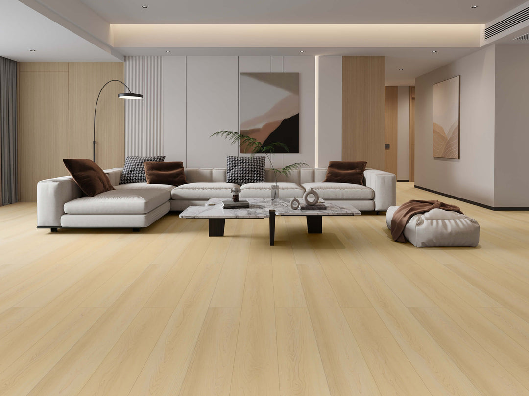 Light oak laminate flooring shown in a modern, minimalist living room setting with a white sectional sofa. Available at Advanced Flooring Waterloo.