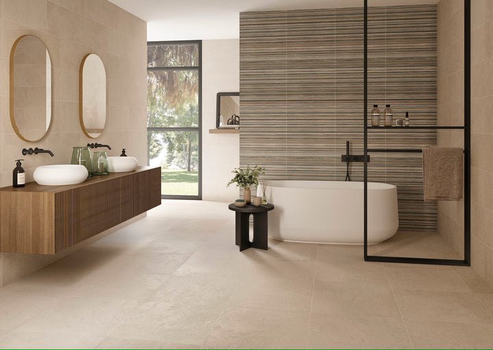 A modern bathroom featuring matte glazed porcelain wall tiles with a subtle convex texture in beige, gray, and anthracite colors.