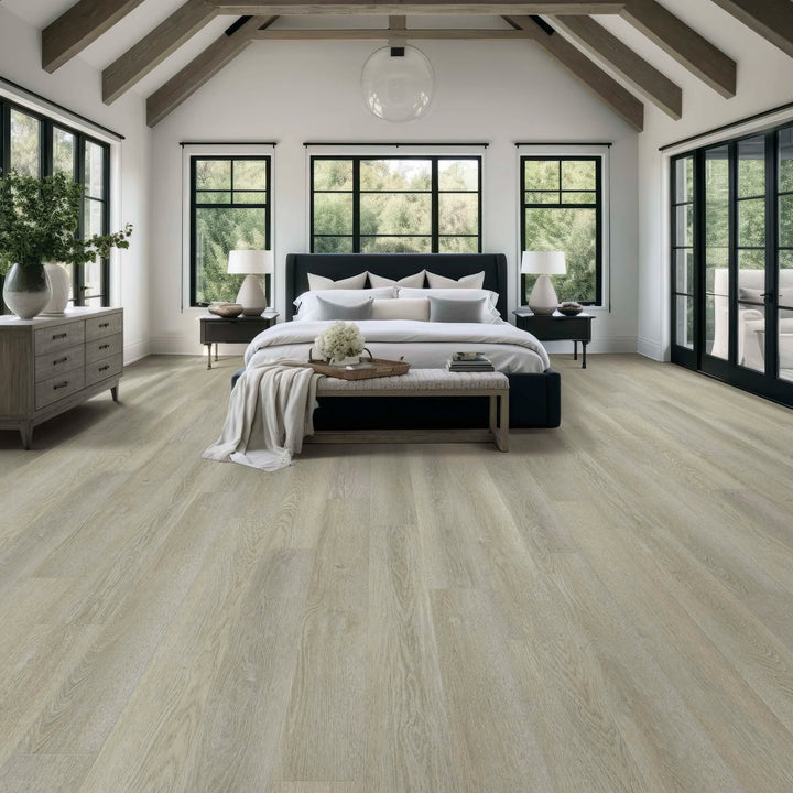 Modern bedroom with wooden flooring, large windows, and a bed.