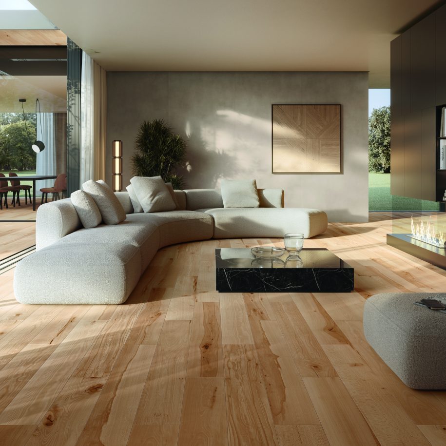 Modern living room with a large gray sectional sofa on a wooden floor.