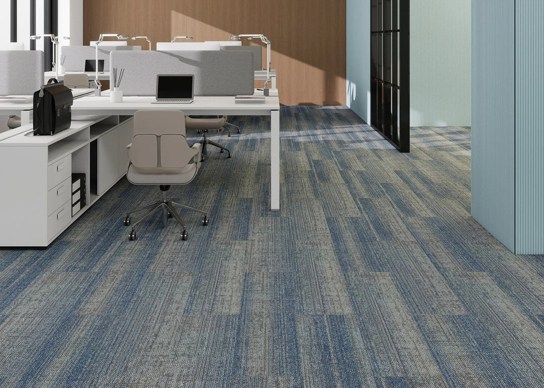 Modern office space with desks, chairs, and large windows.