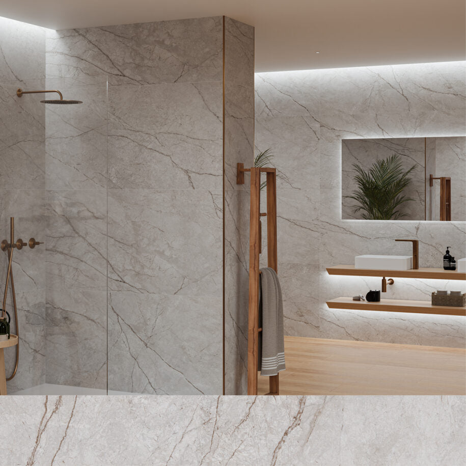 Modern bathroom with marble walls, a shower, and a vanity area.
