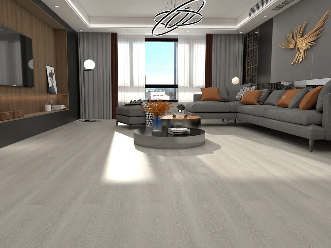 Modern living room with a gray sectional sofa, coffee table, and decorative elements.