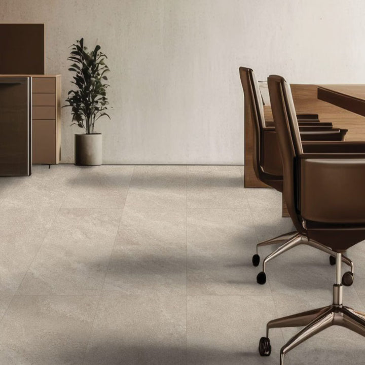 Modern office setting with a long wooden table and chairs, a plant, and a cabinet.