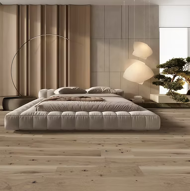 Modern bedroom with a large bed, floor lamp, and decorative elements.