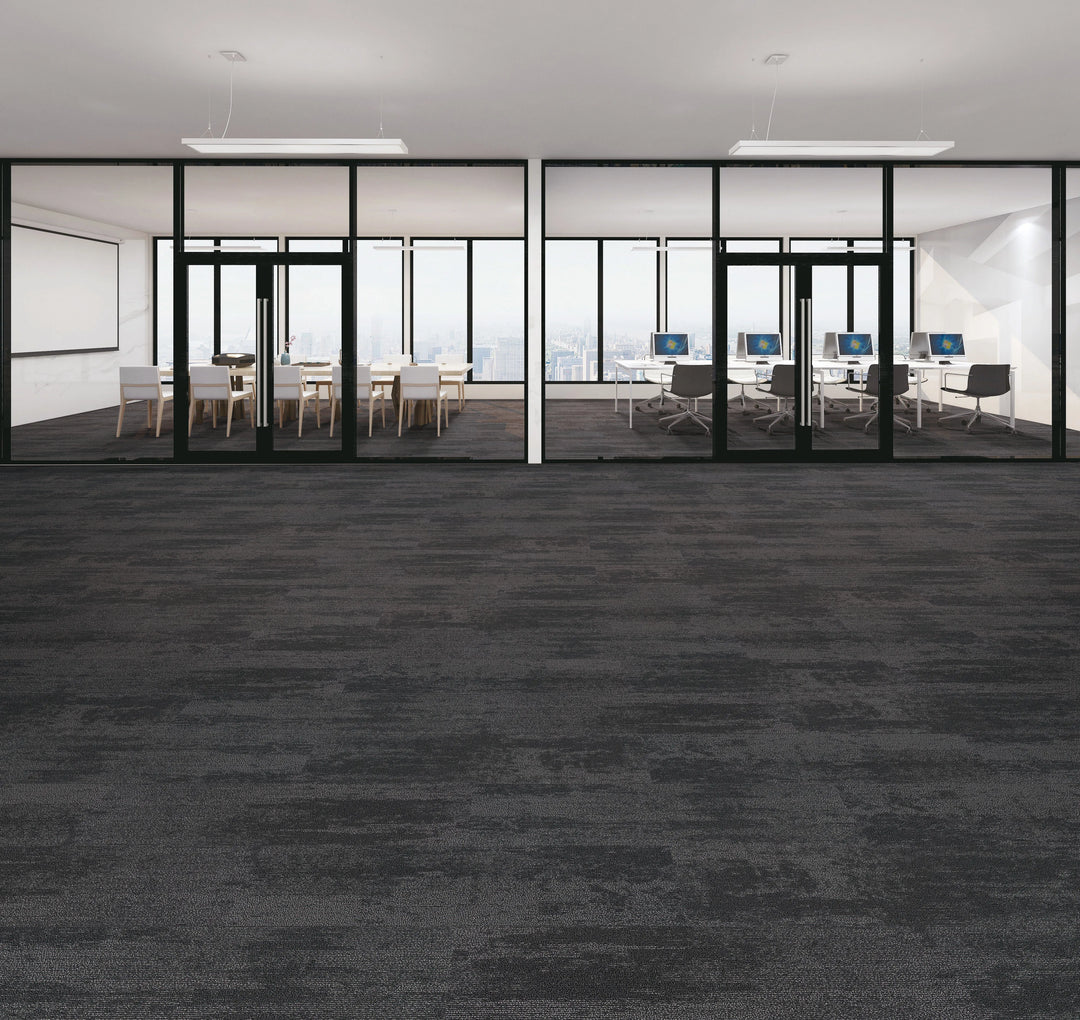 Modern office space with glass walls and carpeted floor
