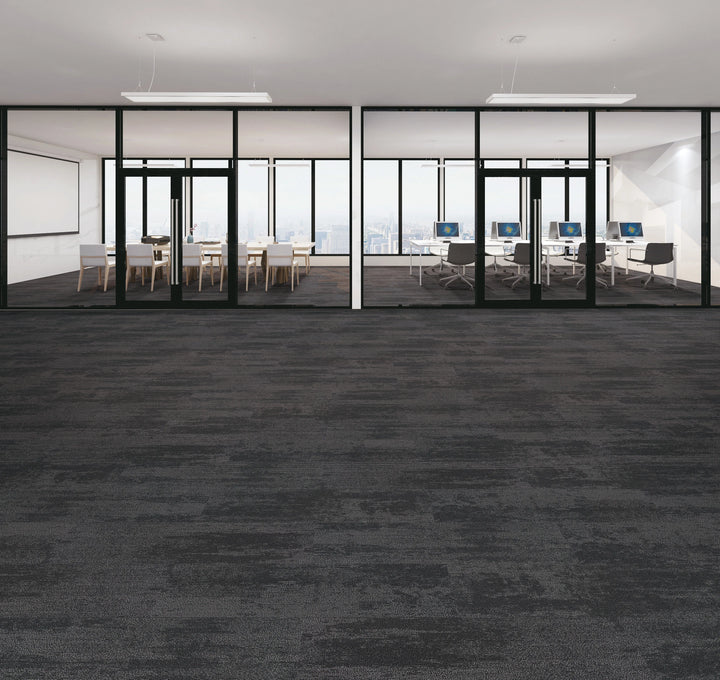 Modern office space with glass walls and carpeted floor