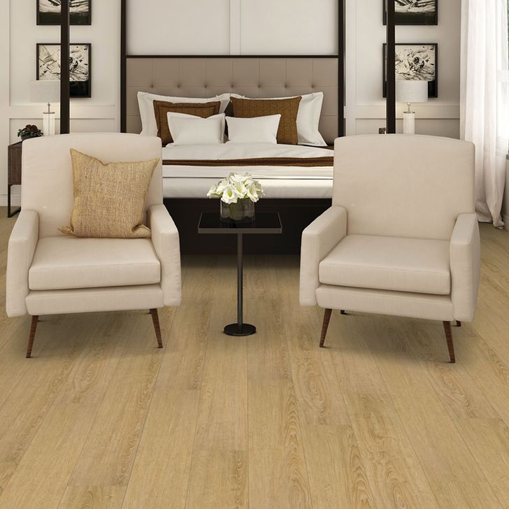 Two beige armchairs in a living room setting with a coffee table and decorative elements.