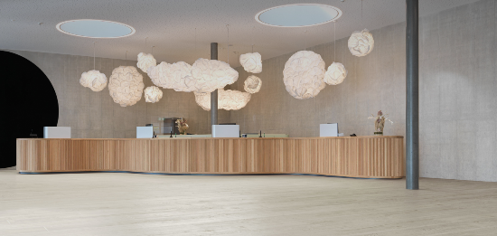 Modern interior with a curved wooden reception desk and decorative ceiling lights.