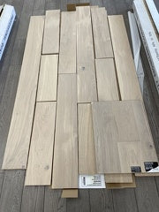 Planks of Snowwhite VIDAR premium American Oak engineered hardwood flooring compared with the flooring sample.