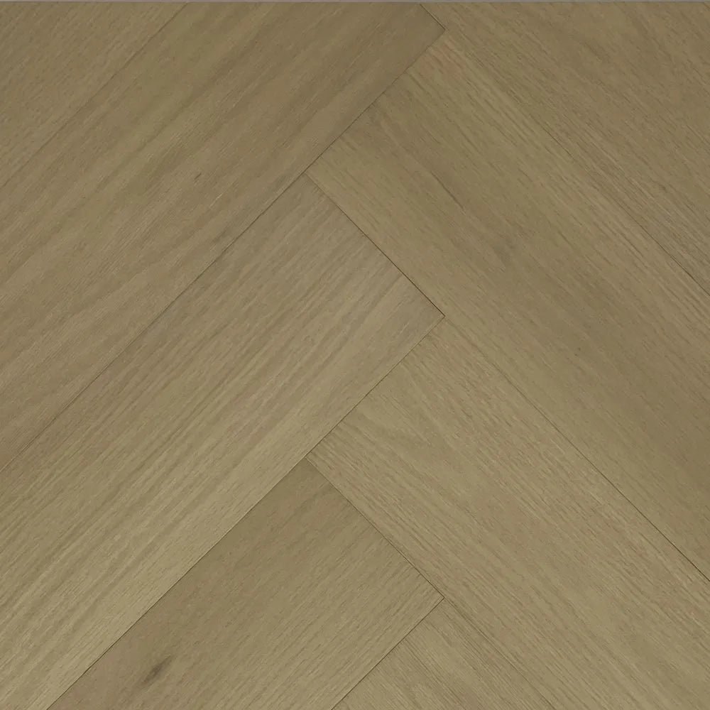 Wooden flooring with a herringbone pattern in a warm brown color.