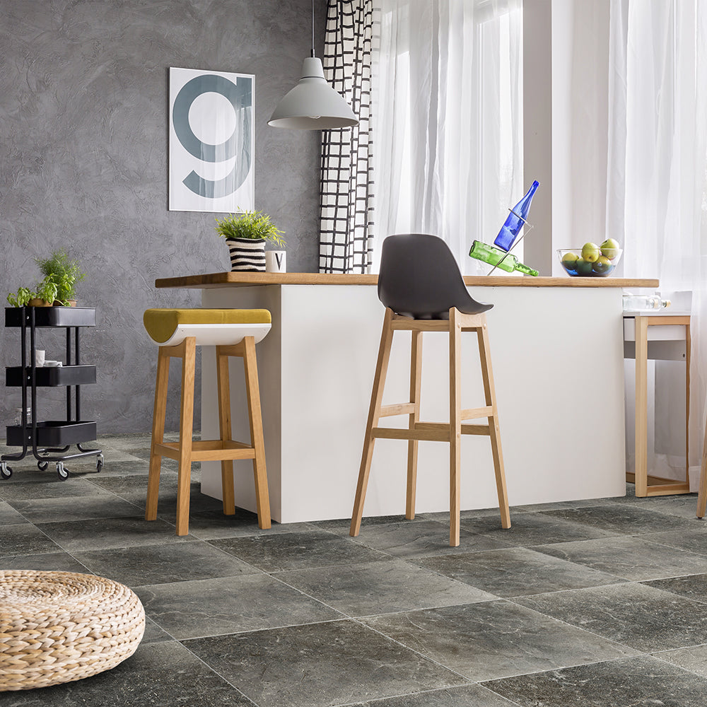 Modern kitchen with bar stools and a tiled floor