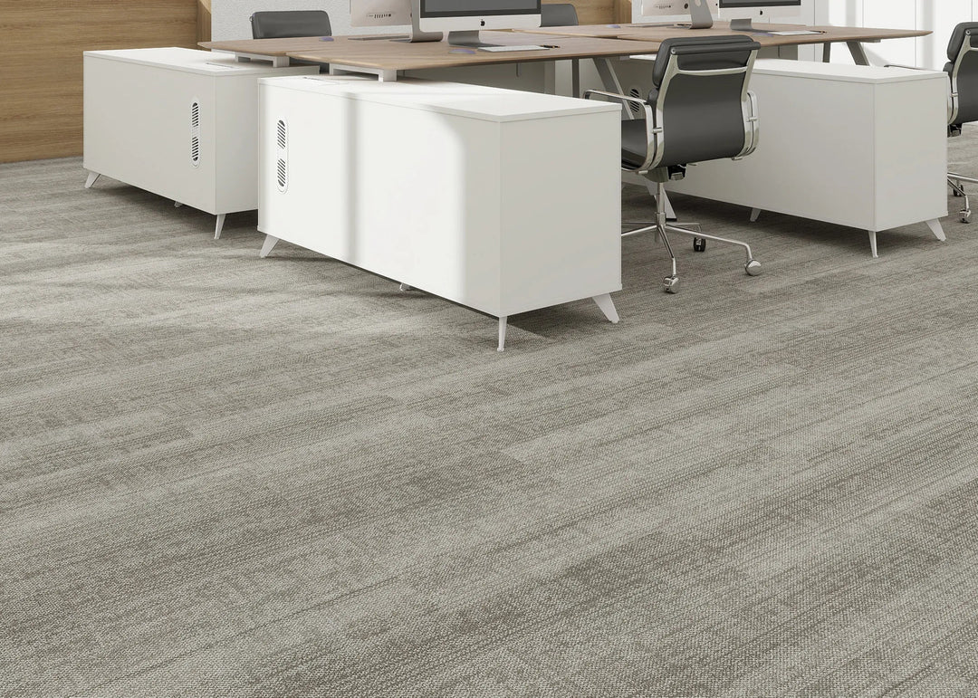 Office floor with gray carpet tiles and white office furniture