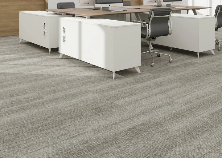 Office floor with gray carpet tiles and white office furniture