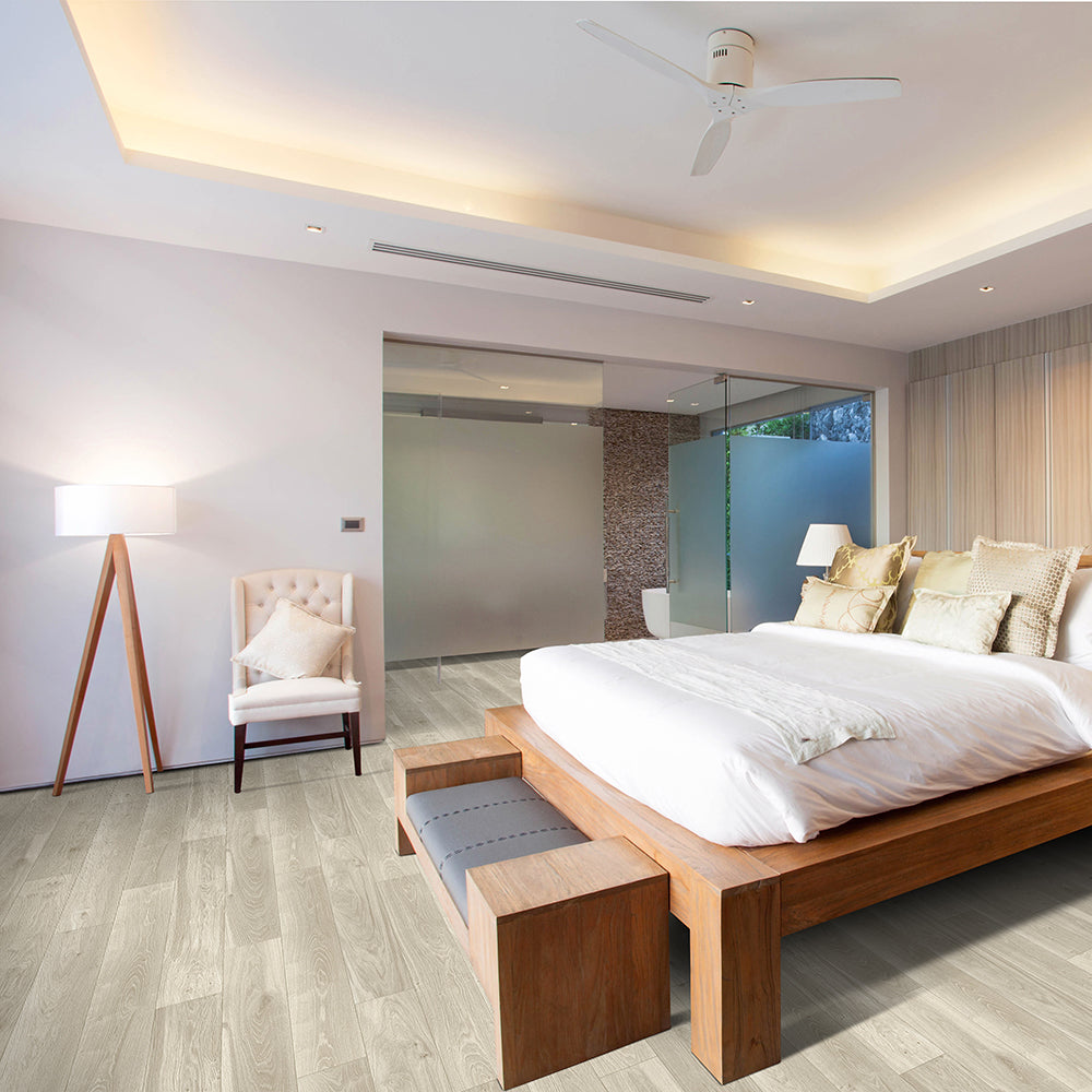 Modern bedroom with wooden bed, chair, and lamp.