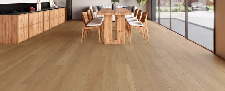 Wooden flooring in a modern kitchen with a dining table and chairs.
