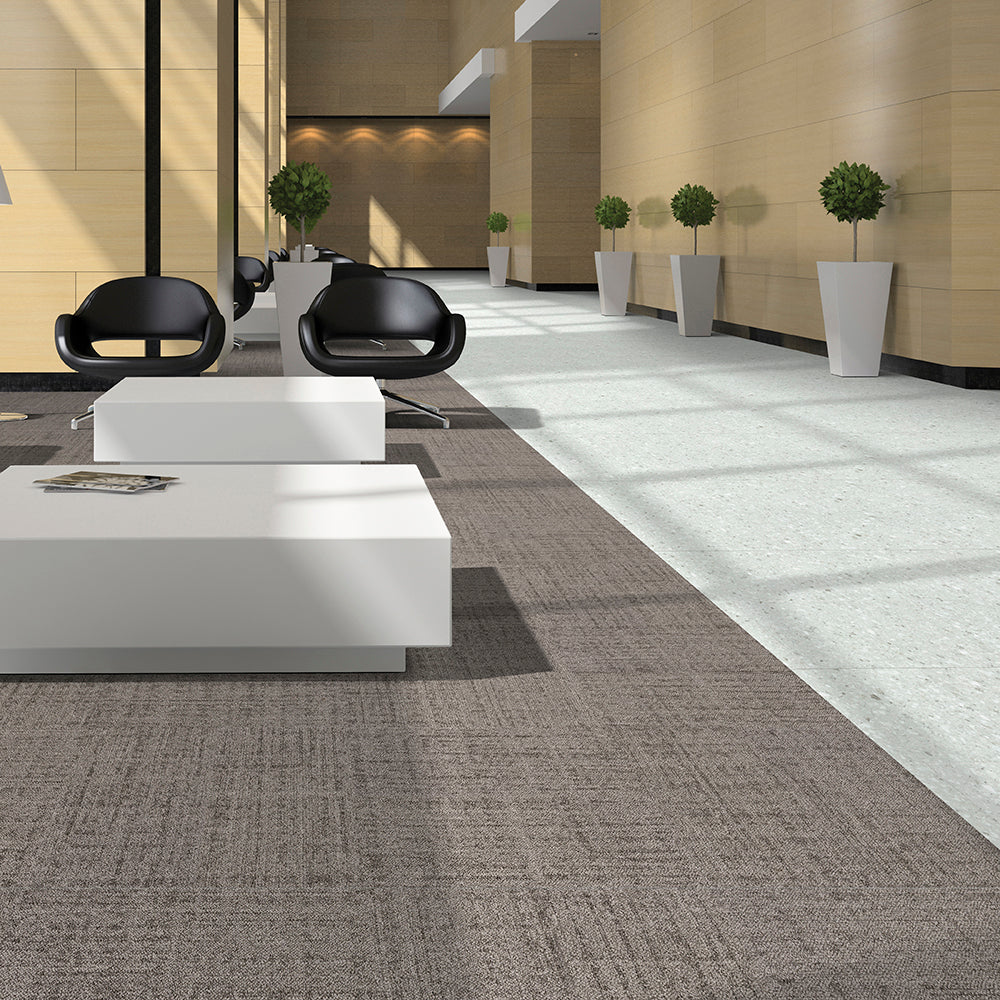 Modern office interior with white desks and black chairs.