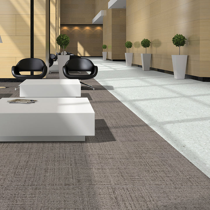 Modern office interior with white desks and black chairs.