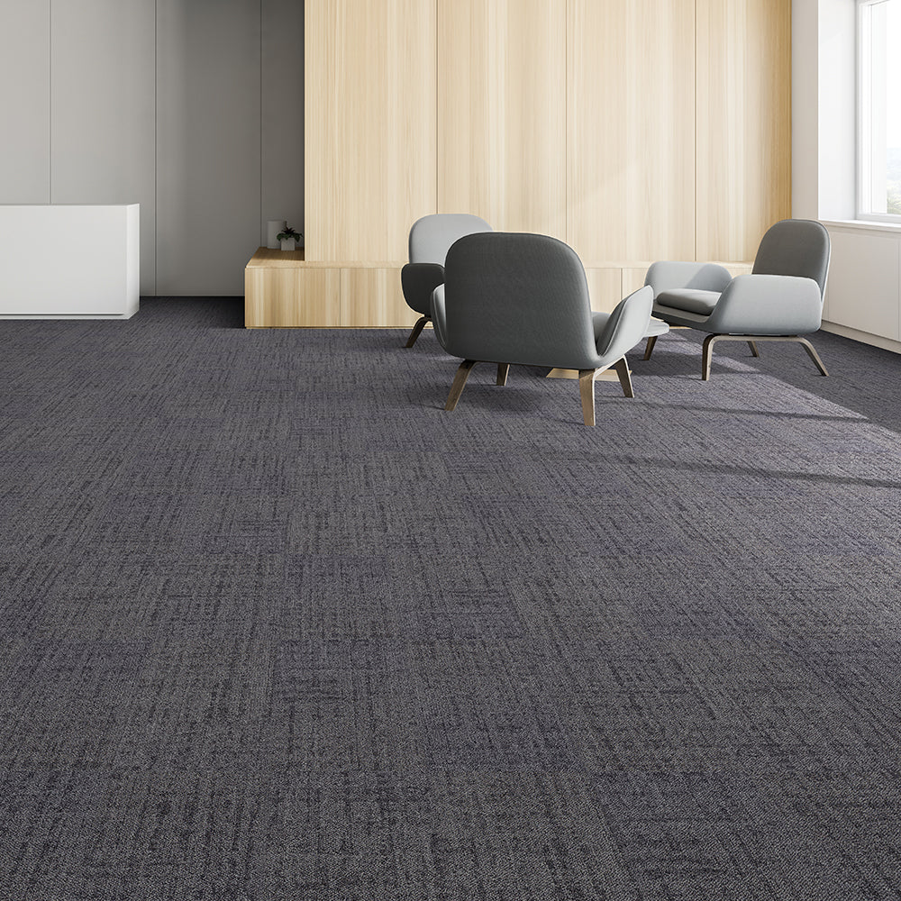 Modern office space with gray chairs and a textured gray carpet.