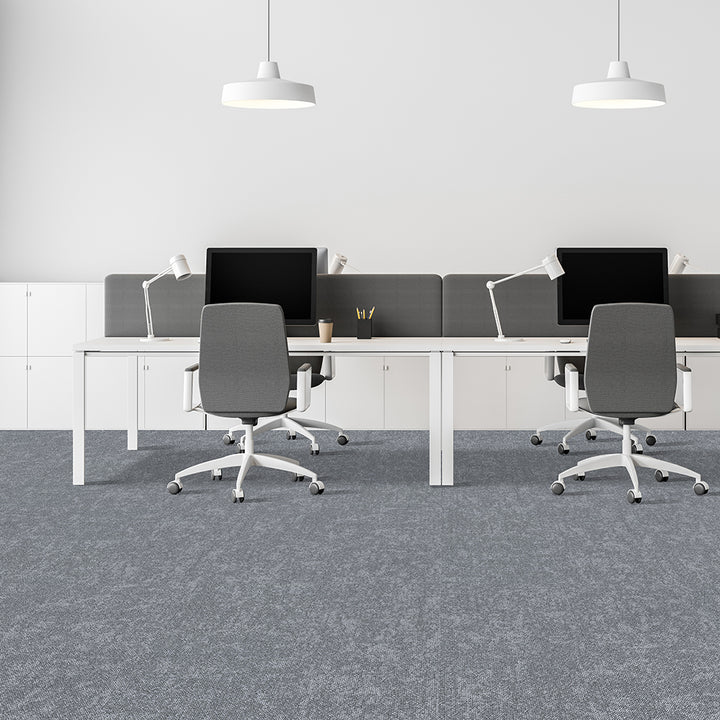 Modern office setup with desks, chairs, and computer monitors in a minimalistic design.