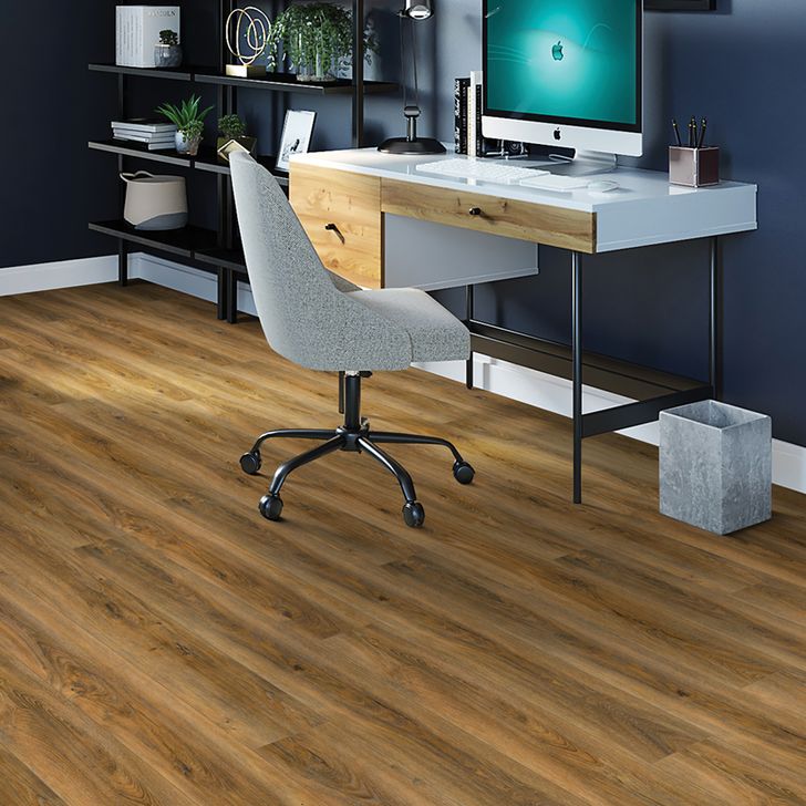 Modern office desk with computer setup and chair on wooden floor