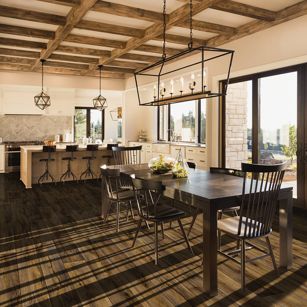 Modern kitchen with wooden dining table and chairs, large windows, and a high ceiling.