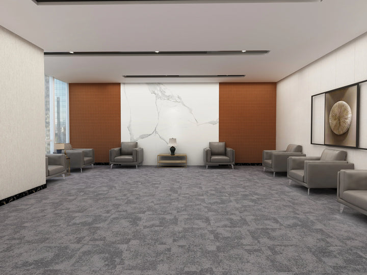 Modern waiting room with gray chairs and a marble wall.