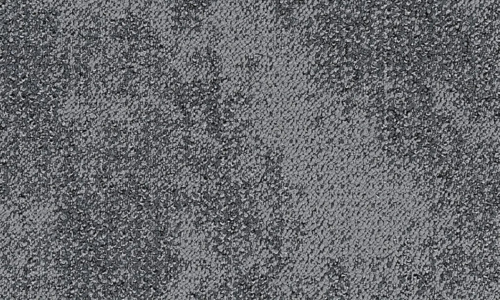 No identifiable objects, just a pattern of black and white dots on a textured surface.