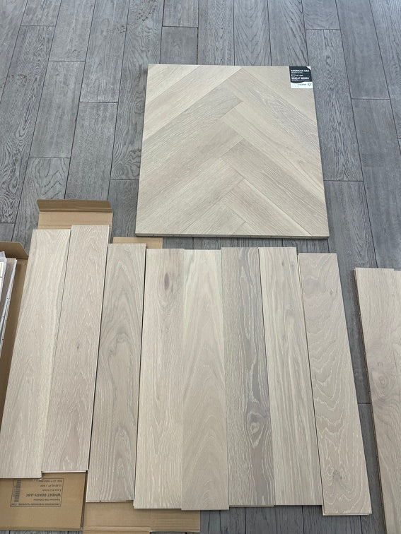 A close up of Wheat Berry VIDAR premium 5” American oak engineered hardwood flooring in herringbone.