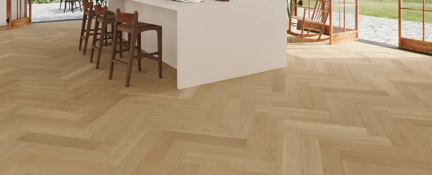 Room view of Whispering Moor engineered hardwood from Fuzion's Velvet Grove Herringbone collection. Available at Advanced Flooring Waterloo.