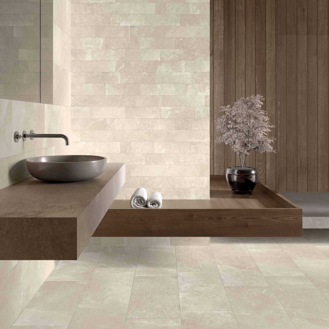 Bathroom interior with tiled walls and floor, featuring a sink and decorative elements.