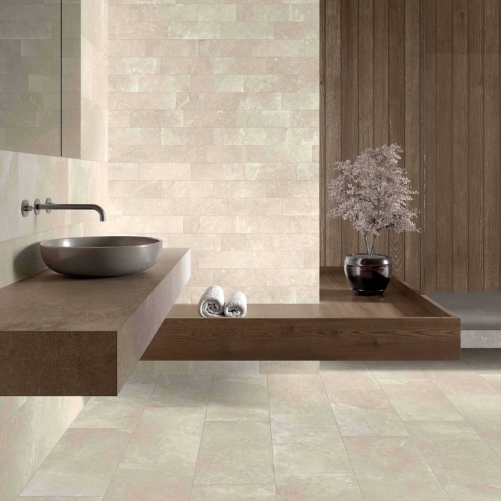 Bathroom interior with tiled walls and floor, featuring a sink and decorative elements.