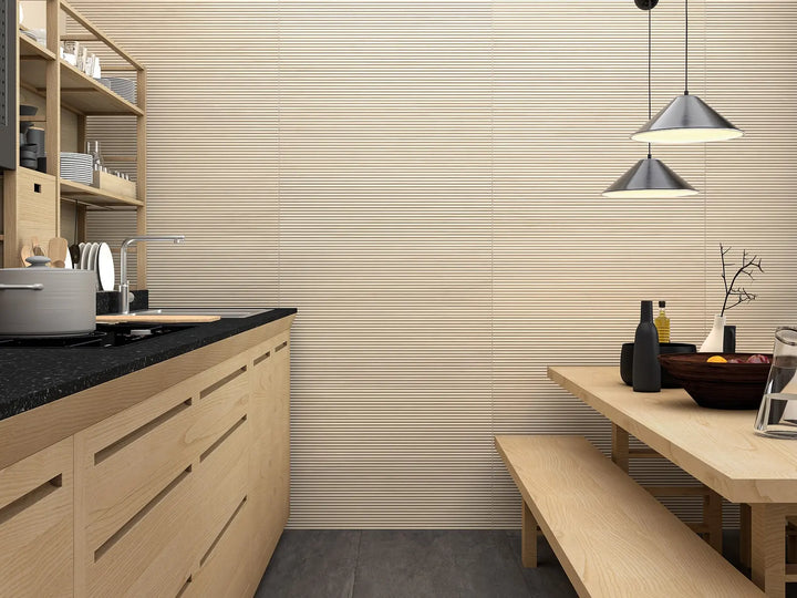 Modern kitchen with wooden cabinets, black countertop, and dining table.