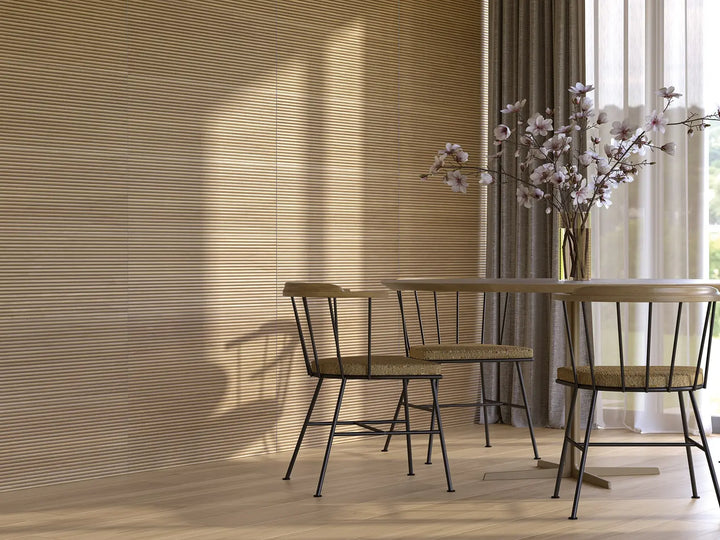 Dining area with wooden table and chairs against a textured wall.