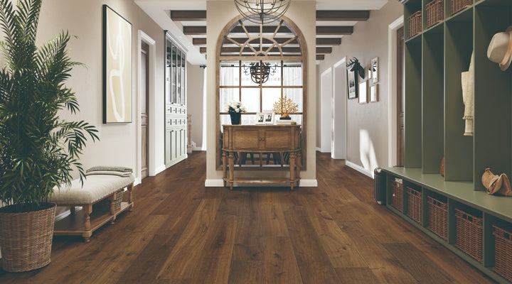 Modern interior featuring Bronze Dust white oak engineered hardwood flooring with wide 7-1/2 inch planks in dark brown finish from the Atelier Collection