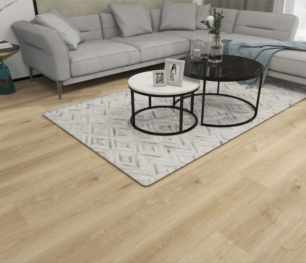 Nikko 12mm waterproof laminate flooring by Canadian Standard installed in a modern interior, showing a grey undertone oak finish. 