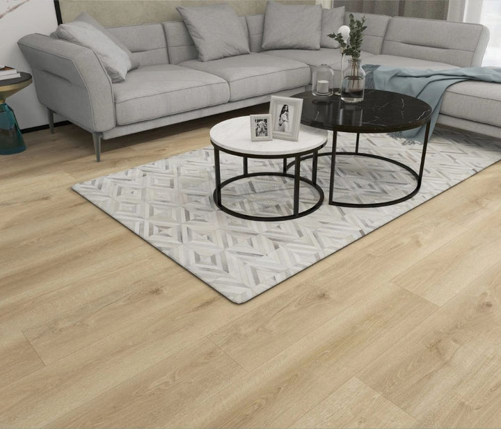 Nikko 12mm waterproof laminate flooring by Canadian Standard installed in a modern interior, showing a grey undertone oak finish. 