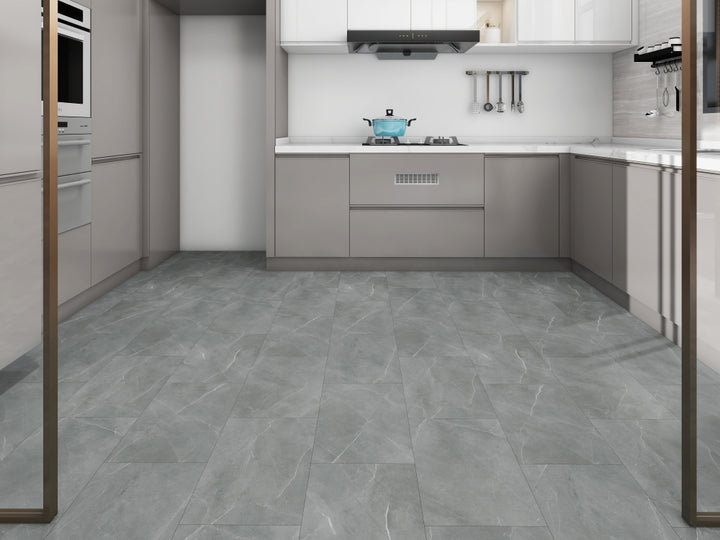 Modern kitchen with gray tiled floor and white cabinets.