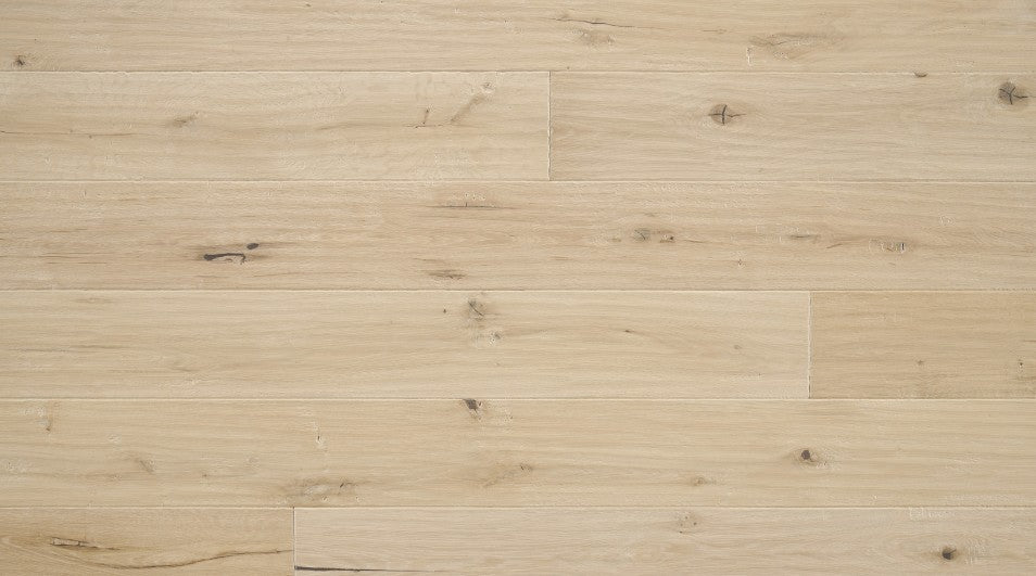 Carrara 7-1/2 inch wide white oak engineered hardwood flooring in natural blonde color with distressed hand-scraped texture